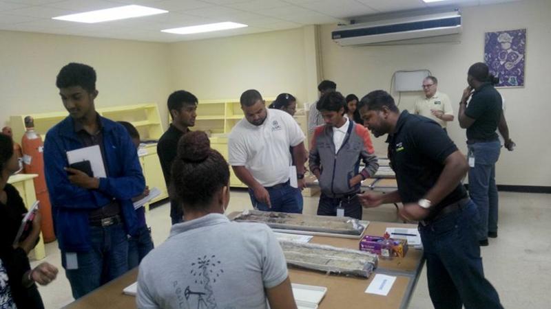 Vishal Nagassar (right) teaches AAPG UWI STA students about cores taken from the Marianne River.