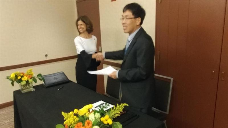 AAPG President-Elect Denise Cox and China University of Technology, Chengdu, Dr. Wen ZHOU, Director (represented by Dr. Keyu LIU), shake hands after signing the document launching the AAPG-CUT Research Center, Chengdu.